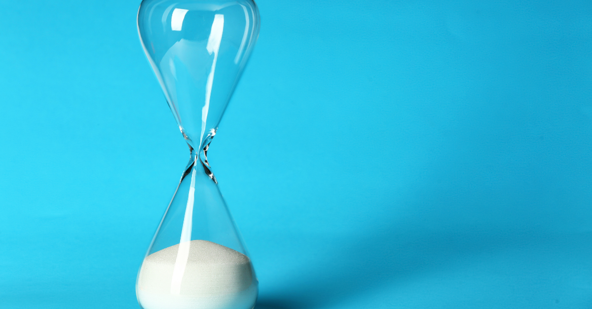 An hourglass is on a blue background